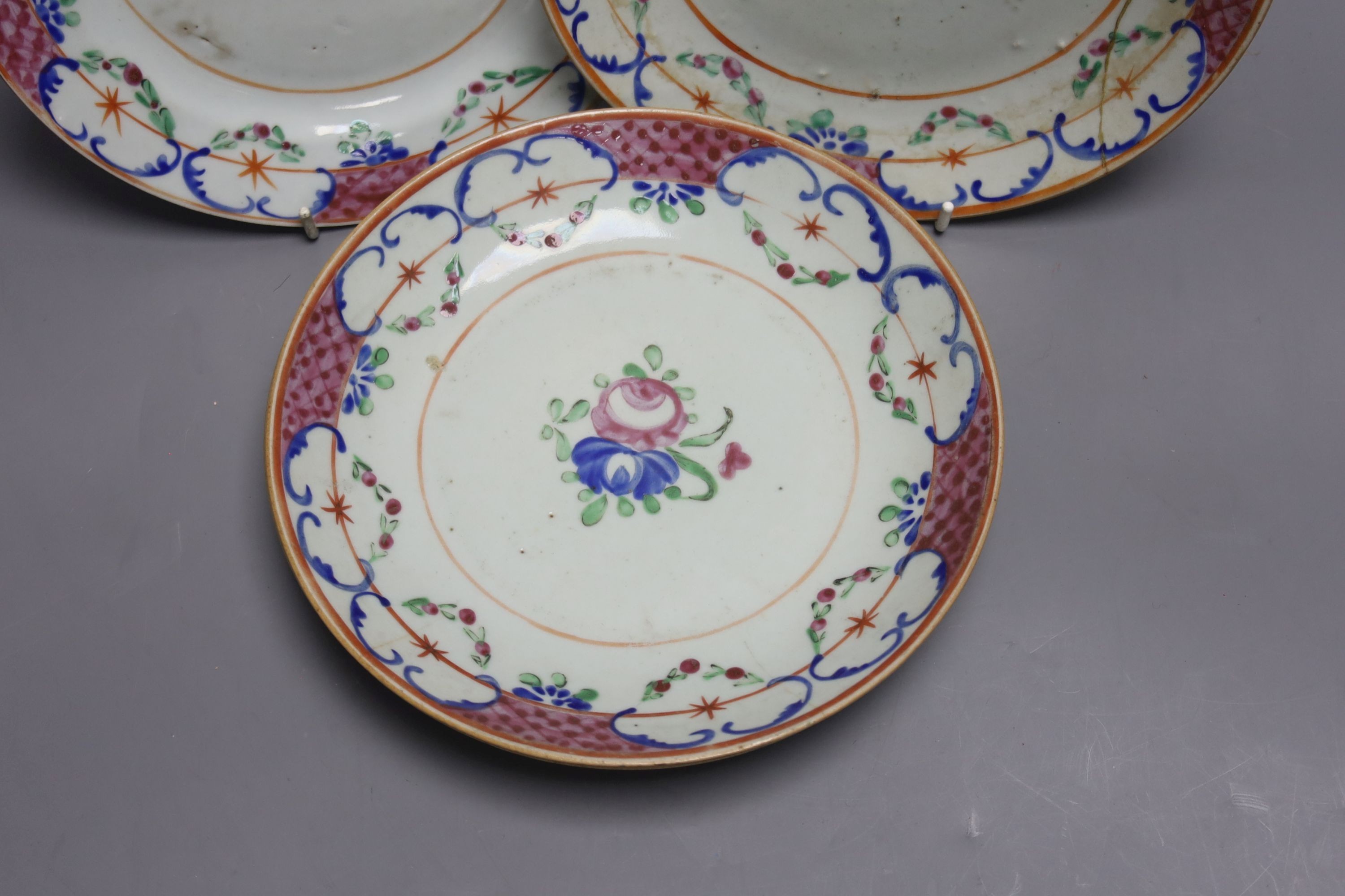 Three early 19th century Chinese polychrome-decorated shallow dishes and a matching plate (one repaired), Dia 22cm